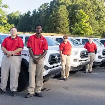 tpc techs standing next to trucks